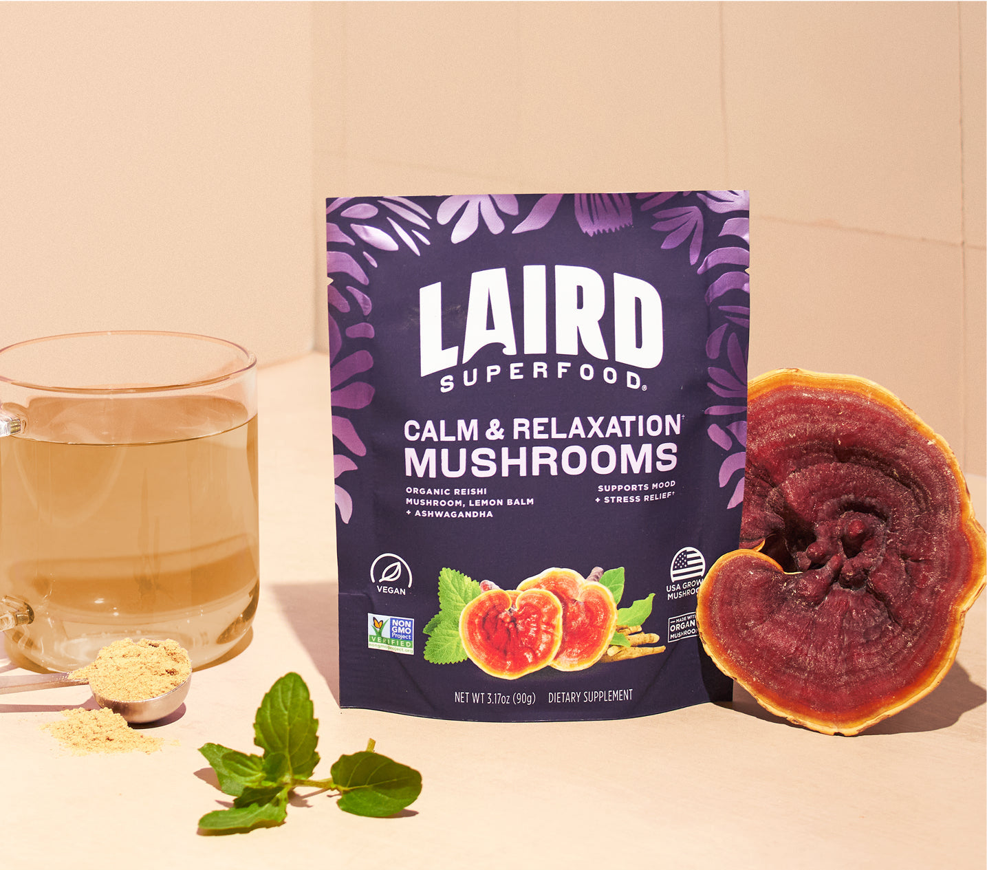 Laird Superfood calm and relaxation mushrooms bag with a reishi mushroom and a glass with the mushroom mix in it