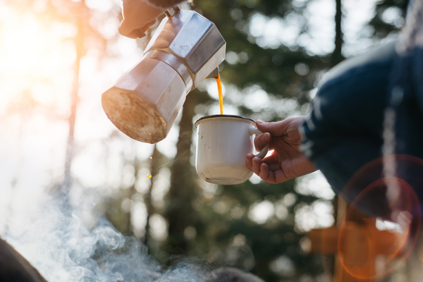 Moka Pot Coffee being poured into an enamel cup in nature