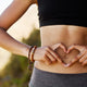 Woman makes a heart shape with her hands, illustrating the importance of gut health. 