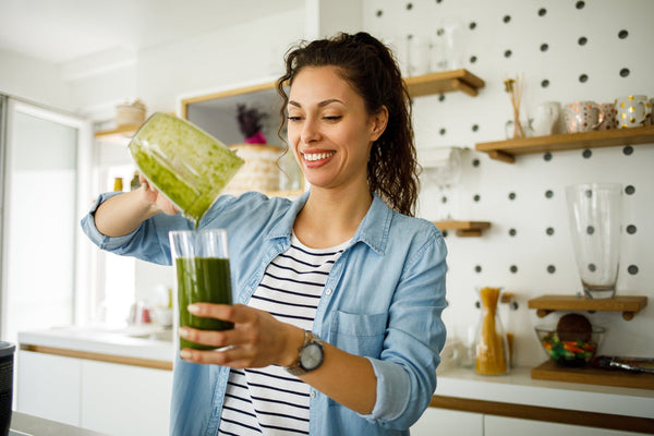 Woman mixes daily greens from her favorite powder.