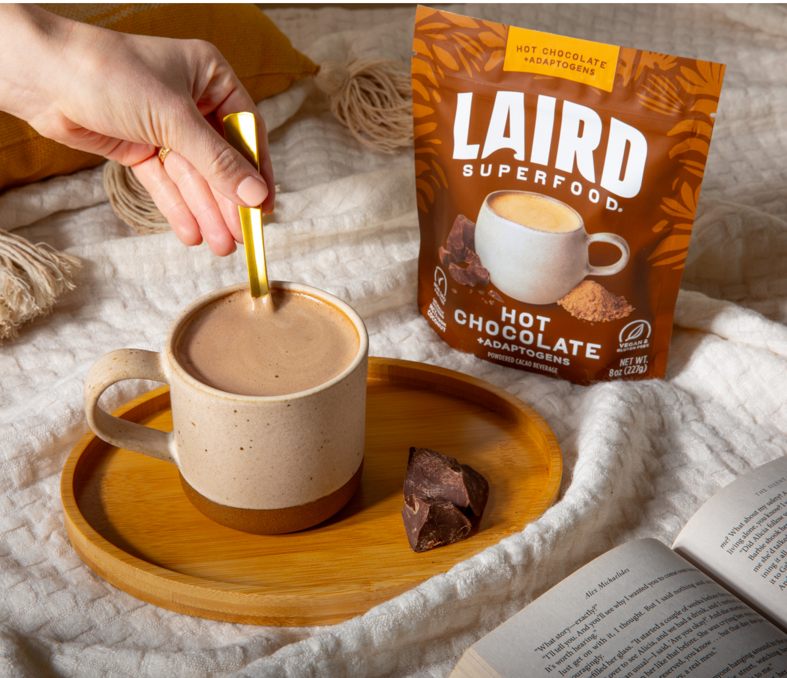 Making Hot Chocolate + Adaptogens in a bed with a book.