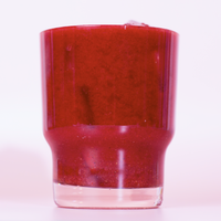 Antioxidant Daily Reds powder mixed in a clear glass with ice