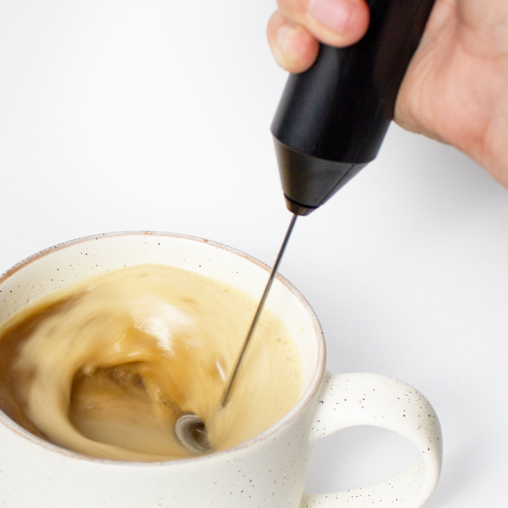 Laird Superfood Battery Powered Frother frothing a cup of coffee and superfood creamer