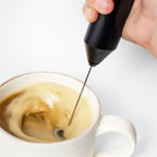 Laird Superfood Battery Powered Frother frothing a cup of coffee and superfood creamer
