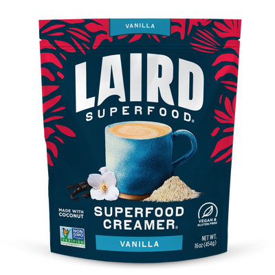Laird Superfood Vanilla Creamer package with a blue mug and vanilla flower on a dark blue background.