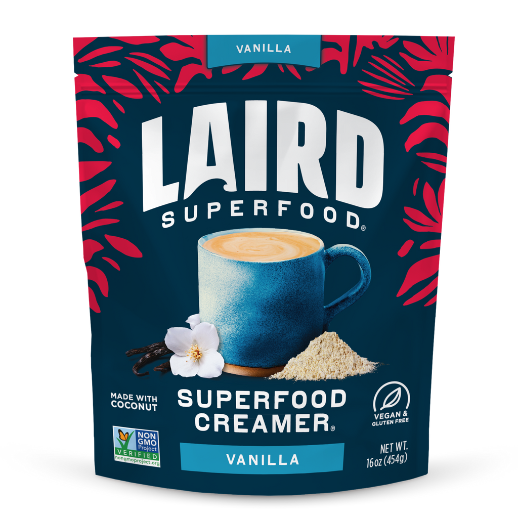 Laird Superfood Vanilla Creamer package with a blue mug and vanilla flower on a dark blue background.