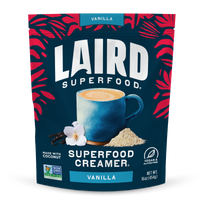 Laird Superfood Vanilla Creamer package with a blue mug and vanilla flower on a dark blue background.