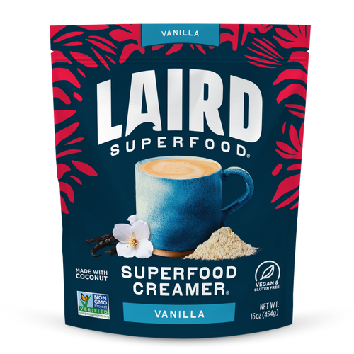 Laird Superfood Vanilla Creamer package with a blue mug and vanilla flower on a dark blue background.