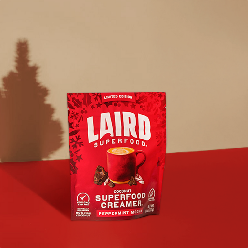 Red package of Laird Superfood Creamer on a red surface with a beige background