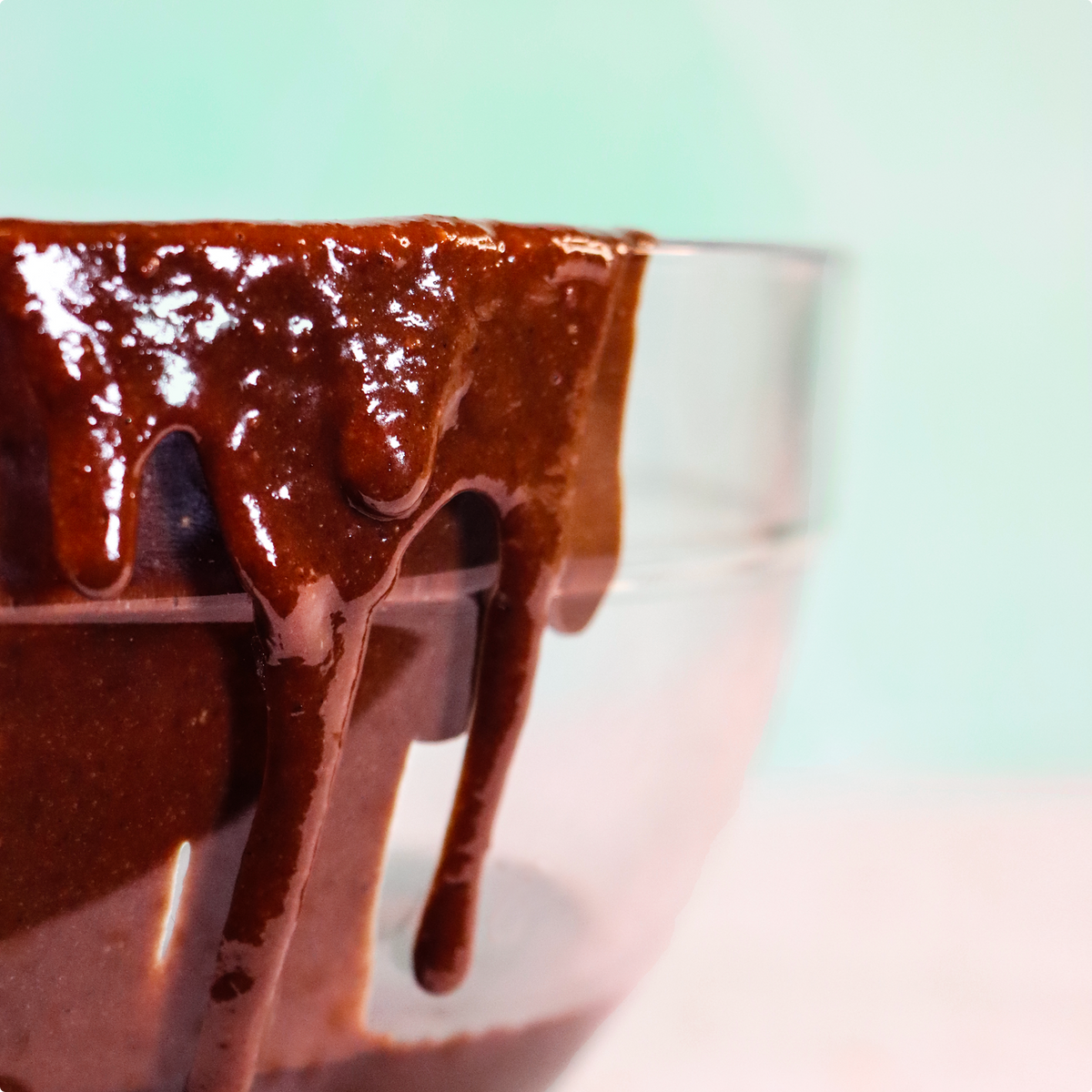Laird Superfood brownie batter dripping down the side of a glass bowl