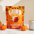 Laird Superfood Coconut Superfood Creamer Pumpkin Spice packaging with pumpkins and a coffee cup on a light background