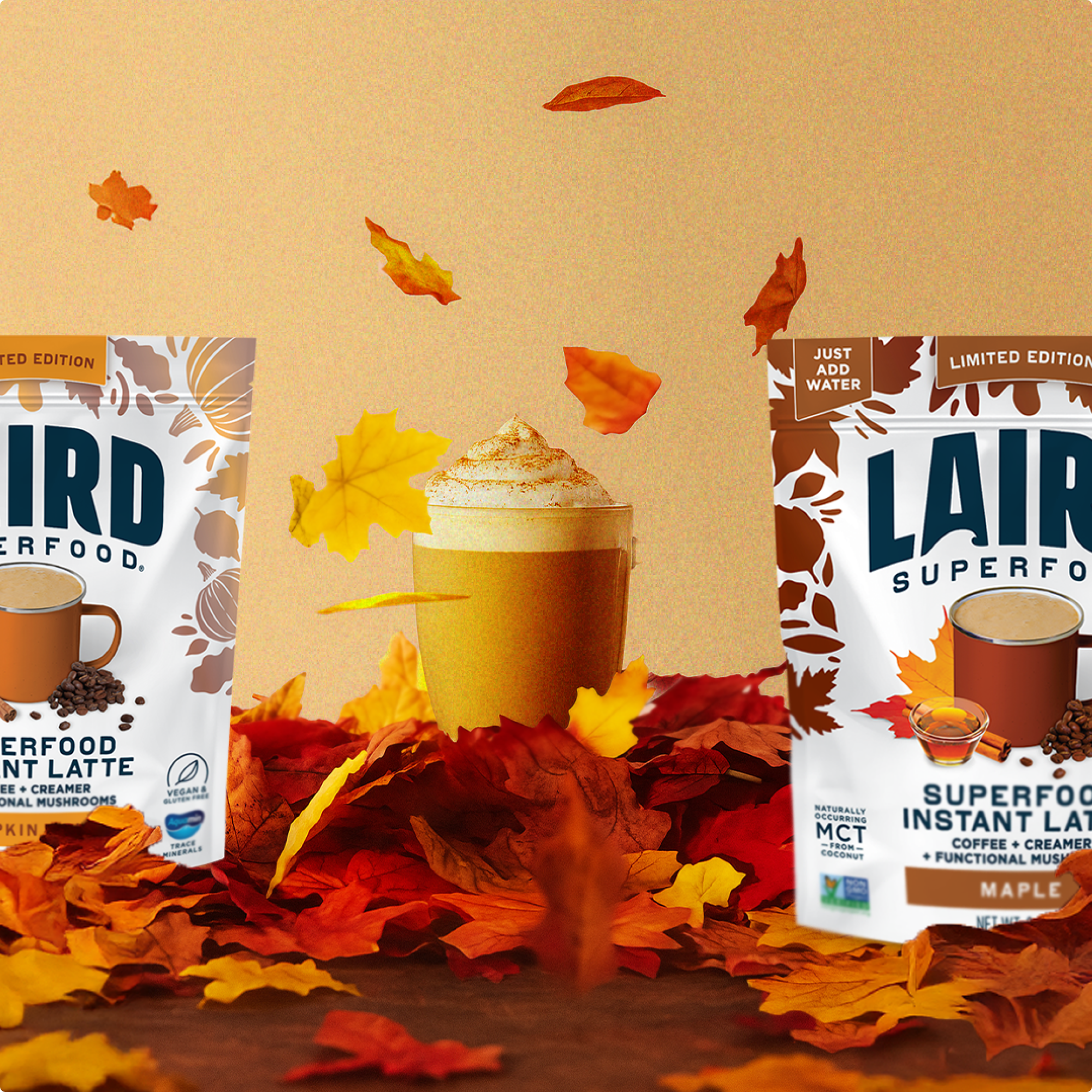Two packages of Laird Superfood Instant Latte with a cup of latte and autumn leaves on a brown background.
