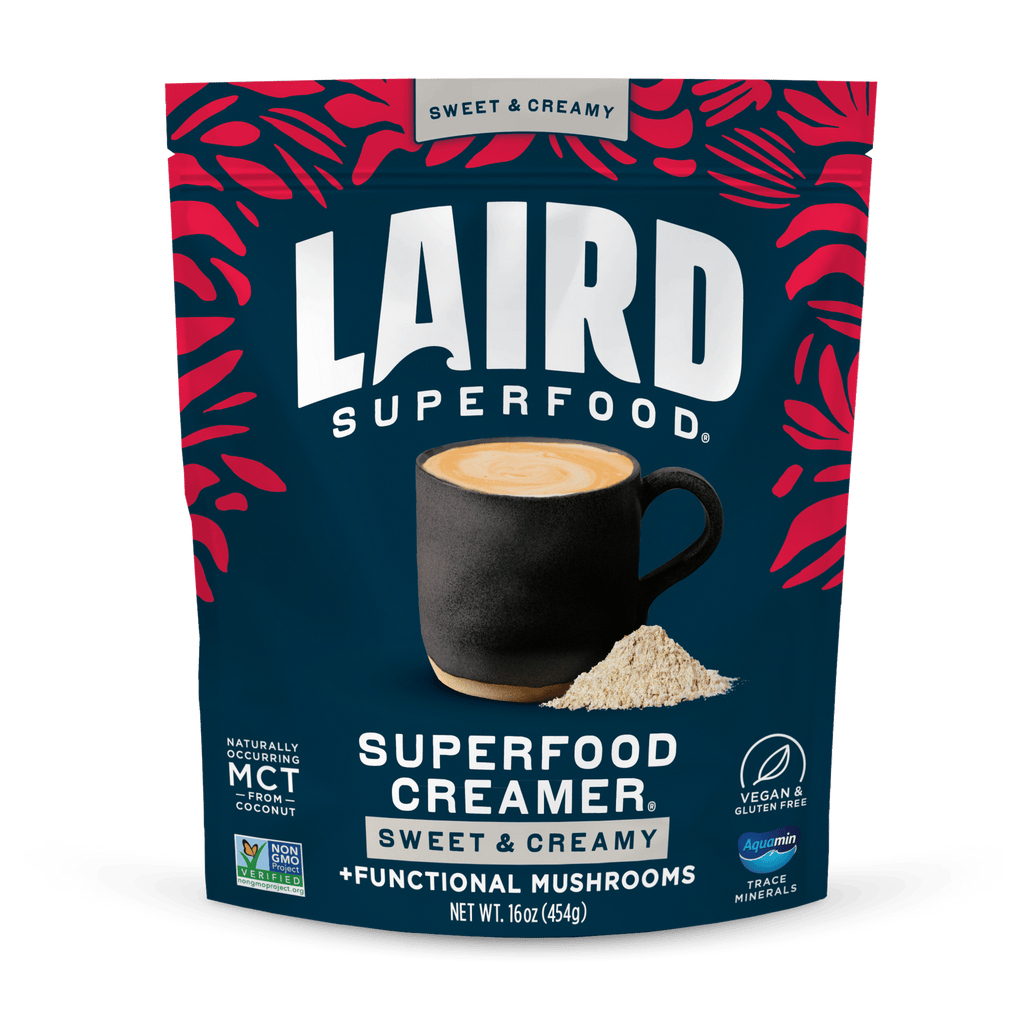 Laird Superfood Sweet & Creamy Superfood Creamer with Functional Mushrooms packaging with a cup of coffee and powder on a blue background