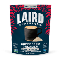 Laird Superfood Sweet & Creamy Superfood Creamer with Functional Mushrooms packaging with a cup of coffee and powder on a blue background