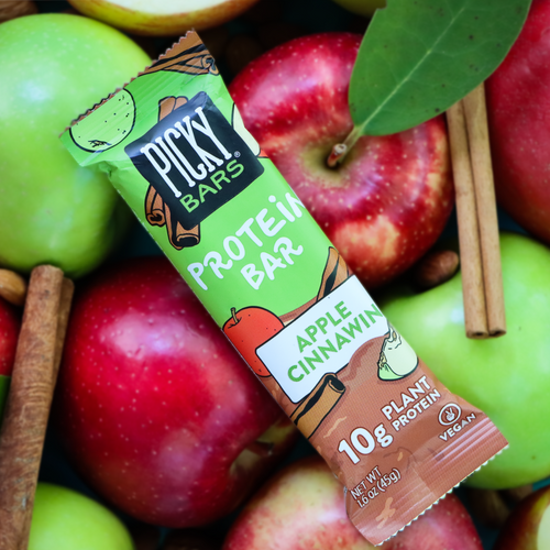 Apple Cinnawin Protein Bar on a pile of apples