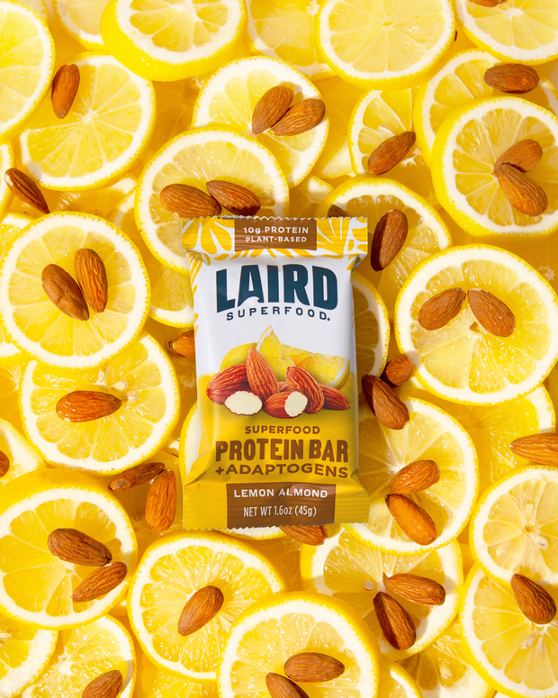 Lemon Almond Protein Bar surrounded by lemon slices and almonds. 