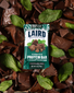 Chocolate Mint Protein Bar in pieces of choclate and mint leaves. 